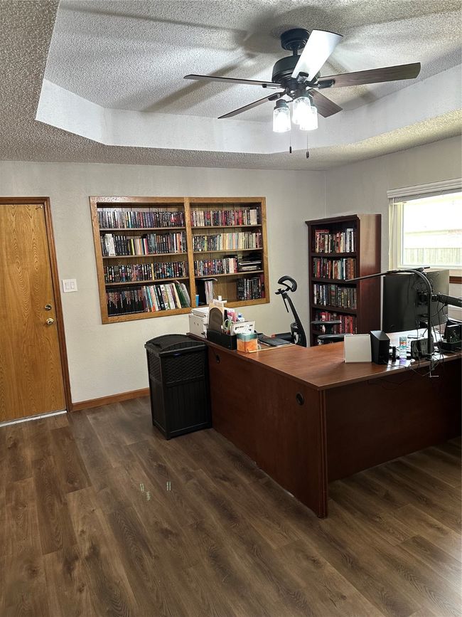 Home office with a ceiling fan, a textured ceiling, and dark wood-style floors | Image 4