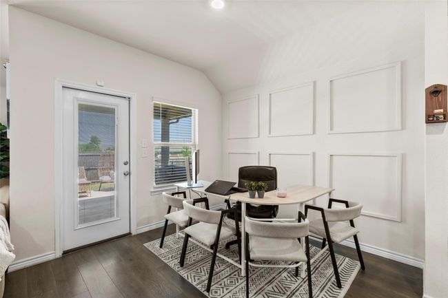 Dining area with vaulted ceiling, baseboards, and dark wood finished floors | Image 9