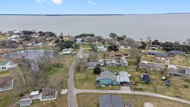 Aerial photo shows a lakeside community. The neighborhood is nestled near Lake Livingston, offering scenic views and a relaxed atmosphere ideal for a tranquil lifestyle. | Image 39