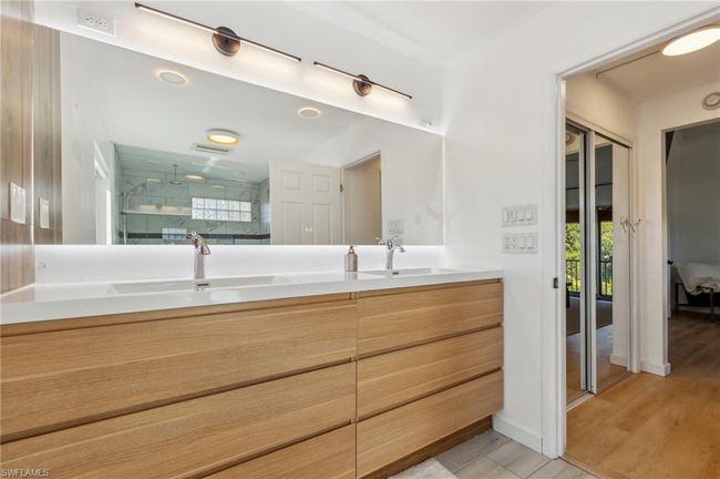 Full bath featuring a sink, a shower stall, double vanity, and visible vents | Image 22