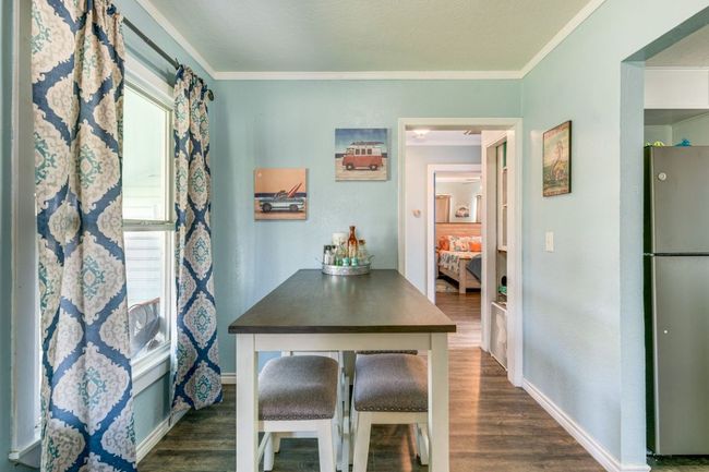 Dining area with baseboards, dark wood-style floors, and crown molding | Image 11