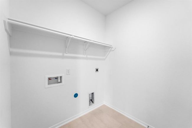 The laundry room layout is carefully planned for optimal workflow with designated areas for washing, drying, and storing. | Image 5