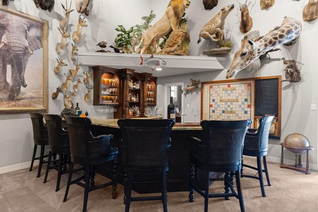 The FULL-SIZE bar is honestly commercial grade. You can easily seat six people at the bar. It has two mini-fridges/wine fridges, sink, dishwasher, and lots of storage...there is also a half bath off the bar which opens up to the outdoor kitchen and pool... | Image 29