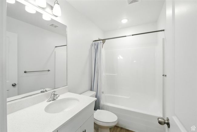 Full bathroom featuring vanity and shower / tub combo with curtain | Image 16