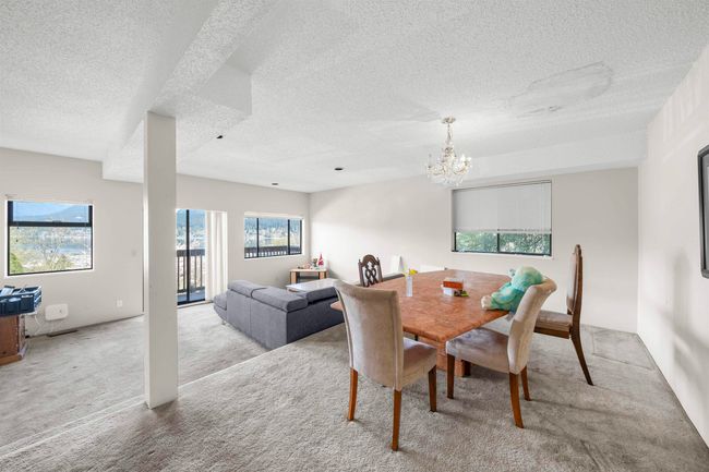 Carpeted dining area with a chandelier and a textured ceiling | Image 27