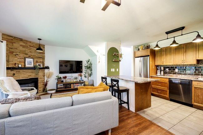 Living area featuring a stone fireplace and light wood-type flooring | Image 4