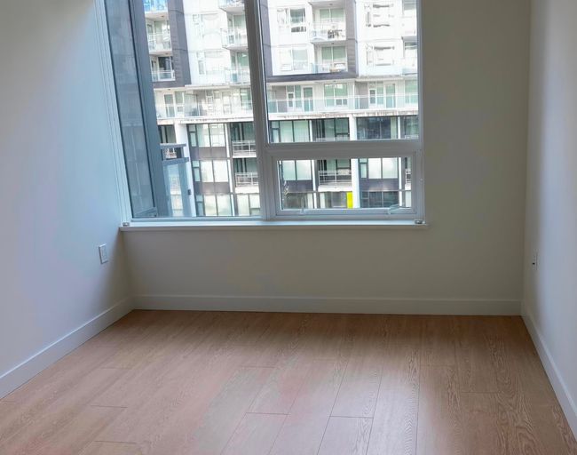 Spare room featuring wood finished floors and baseboards | Image 9