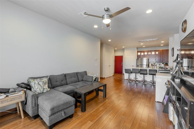 Living room featuring a ceiling fan, light wood-style flooring, and recessed lighting | Image 15