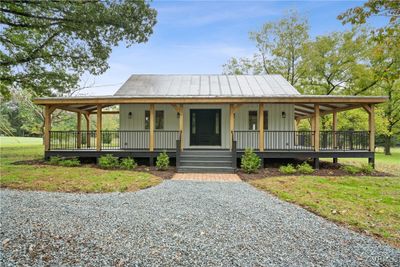 Farmhouse inspired home with a porch and a front yard | Image 1