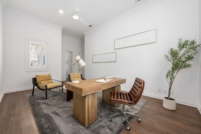 Office area featuring crown molding, dark wood-style floors, a ceiling fan, and baseboards | Image 16