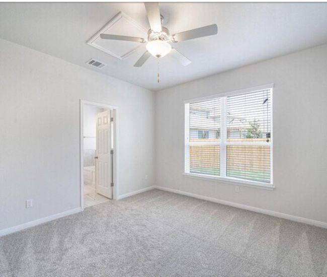 Spare room featuring light colored carpet and a ceiling fan | Image 9