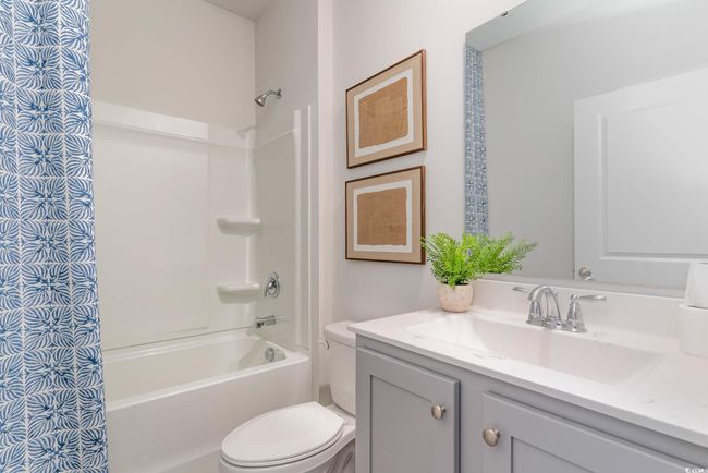 Full bathroom with vanity, toilet, and shower / tub combo with curtain | Image 18