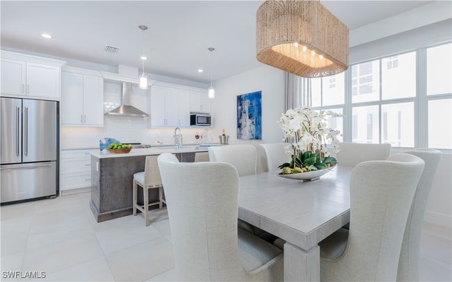 Dining space featuring sink and light tile patterned floors | Image 13