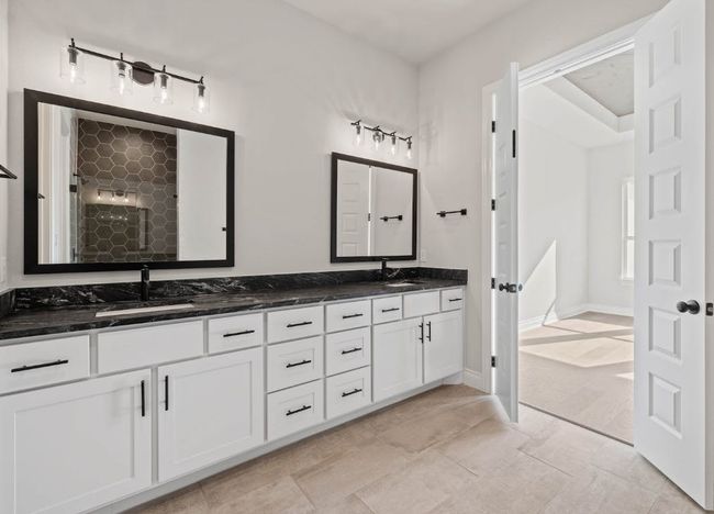 Full bathroom featuring tiled shower, double vanity, and a sink | Image 18