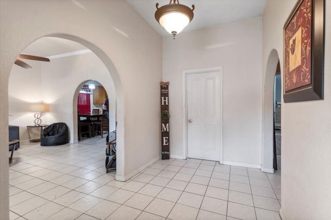 Entrance foyer with arched walkways, light tile patterned floors, and ceiling fan | Image 5