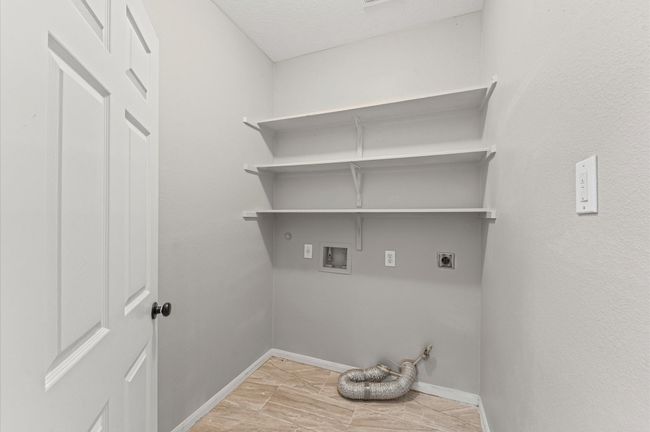 Laundry room conveniently located inside. | Image 9