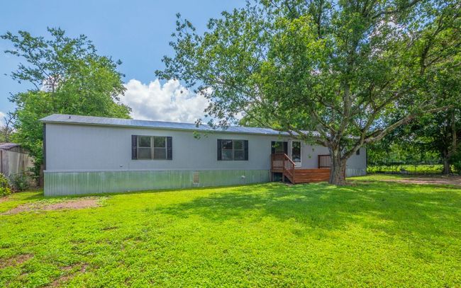 Back of property with a yard and a deck | Image 17