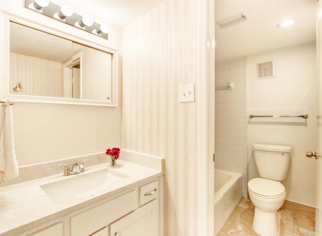 Full bath with vanity, tub / shower combination, and tile patterned floors | Image 25