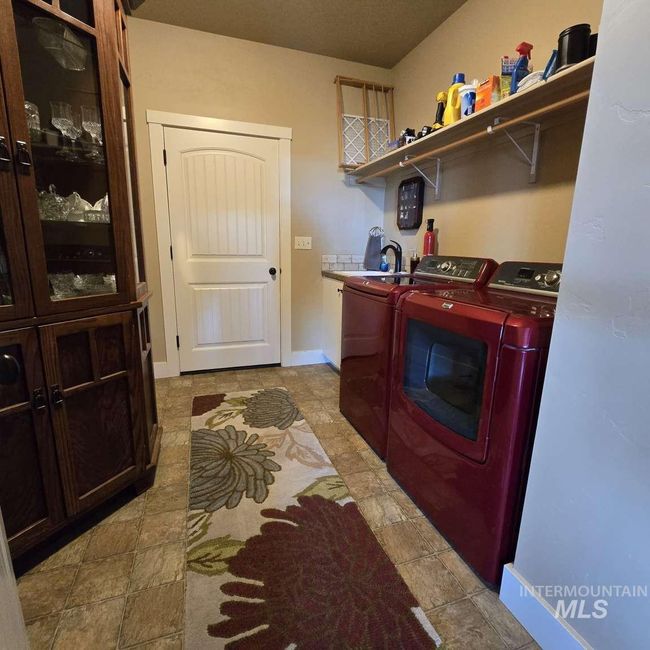 Laundry room with cabinet space and washing machine and dryer | Image 14