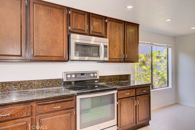 Another view of the kitchen. The breakfast nook can be partially seen at right. | Image 16