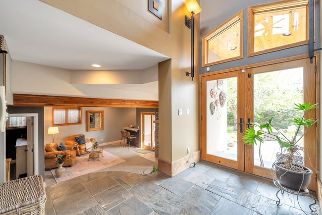Entryway featuring stone tile flooring, recessed lighting, a high ceiling, and baseboards | Image 21