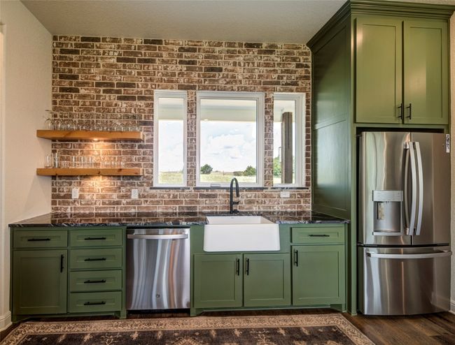 Kitchen featuring appliances with stainless steel finishes, sink, dark hardwood / wood-style floors, and green cabinetry | Image 11