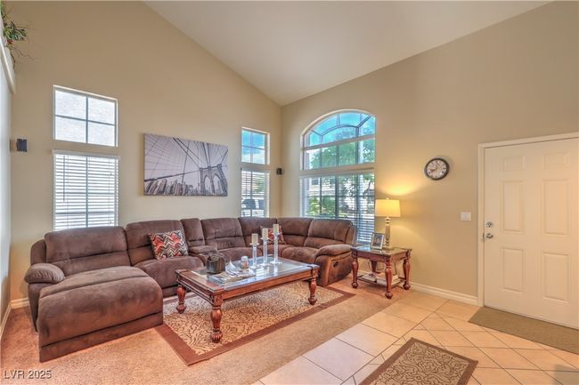 Living room featuring high vaulted ceiling and light tile patterned floors | Image 6