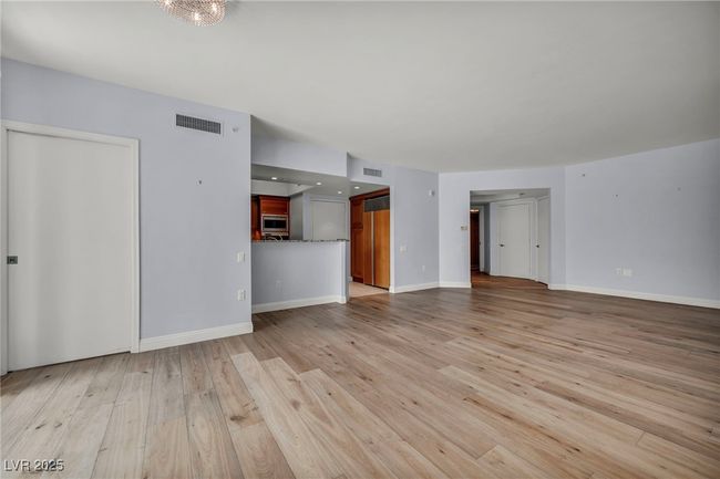 Unfurnished living room featuring light wood-type flooring, visible vents, and baseboards | Image 21