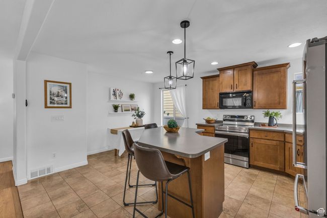 Kitchen featuring staggered cabinets and new stainless steel range. | Image 12