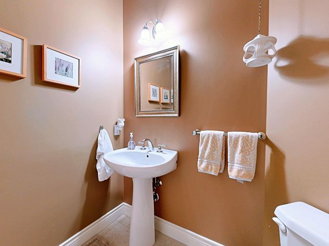 Bathroom featuring toilet and tile patterned floors | Image 19
