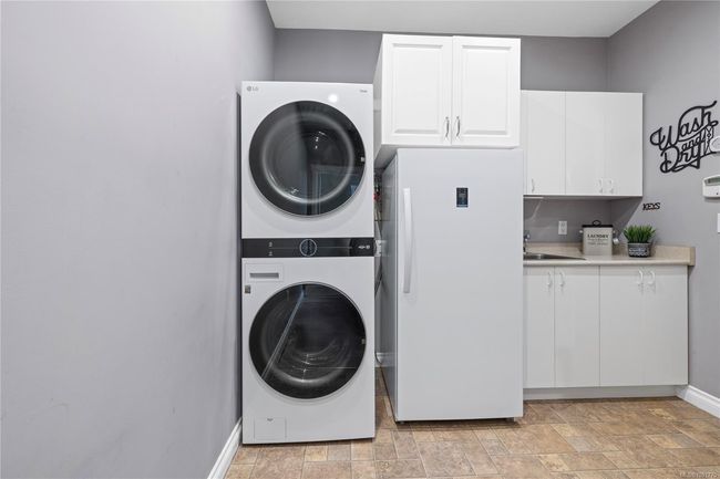 Laundry room with newer stand-up deep freezer | Image 16