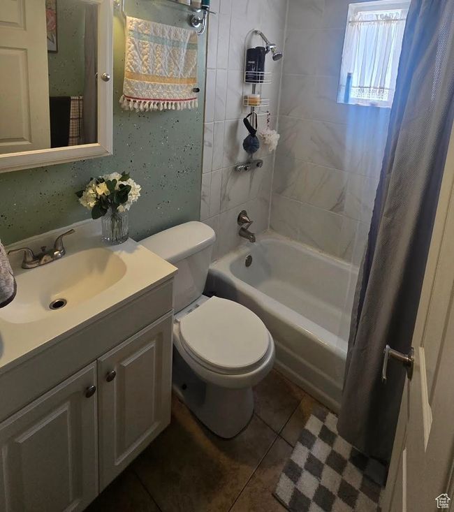 Full bathroom with vanity, tile patterned floors, shower / bath combo, and toilet | Image 14