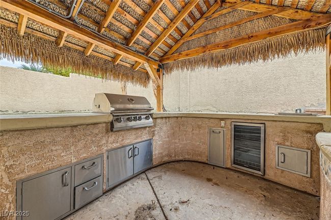 View of patio with wine cooler, a gazebo, and an outdoor kitchen | Image 44