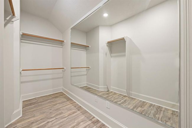 Walk-in closet with flooring to match the bedroom. | Image 41