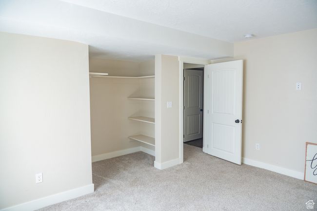 Unfurnished bedroom with carpet floors and a closet | Image 18