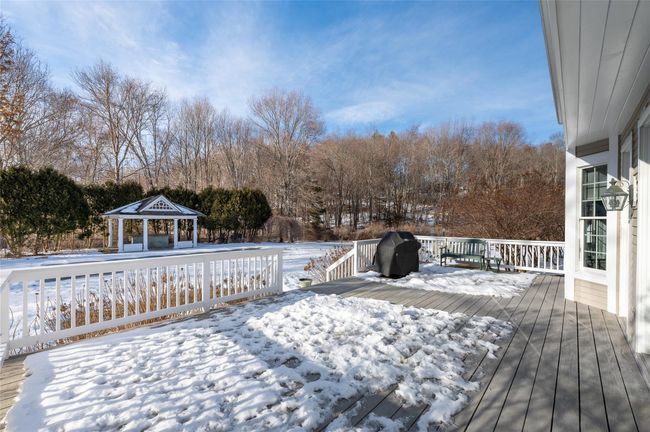 Large deck overlooking level backyard, pool and pool gazebo. | Image 28