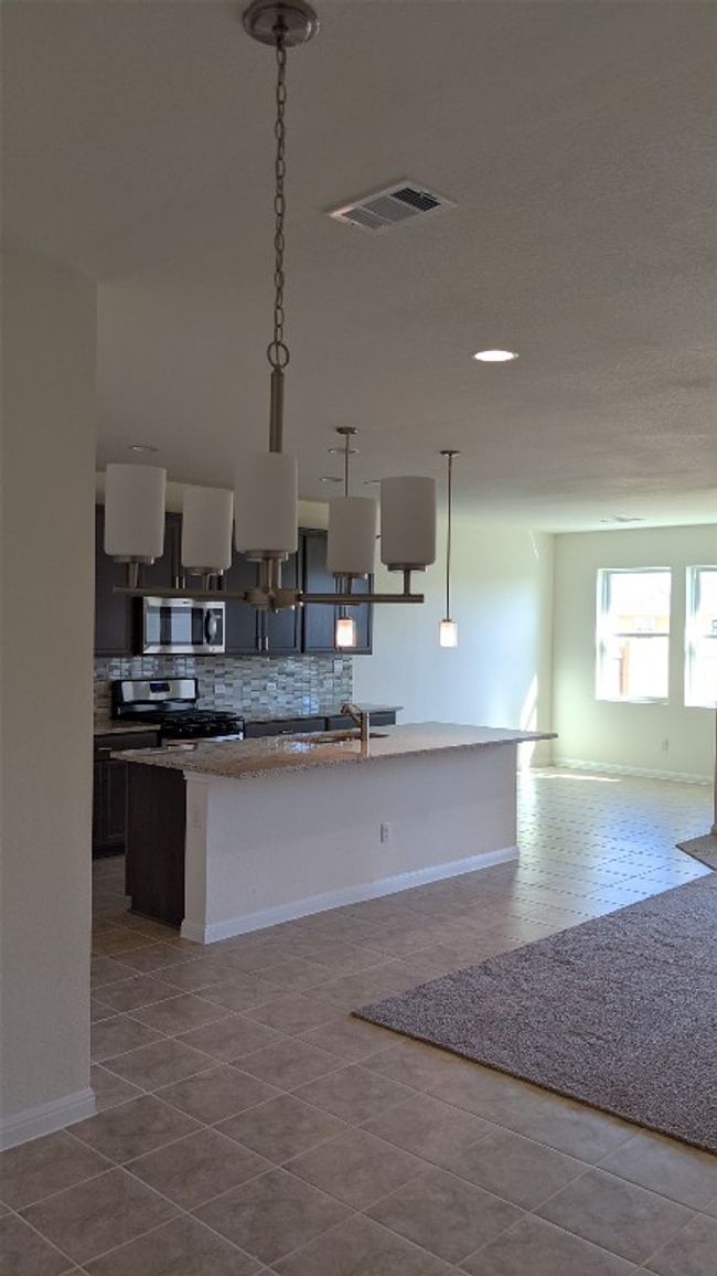 View from dining area into kitchen and breakfast area. The flow of this open floor plan is both functional and elegant. | Image 4