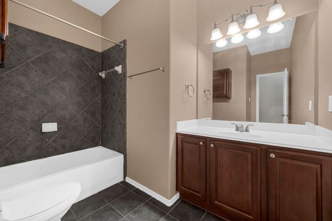A second full bathroom features stylish designer tile. | Image 24