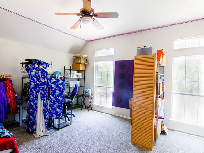 Misc room featuring carpet, ceiling fan, lofted ceiling, and baseboards | Image 11