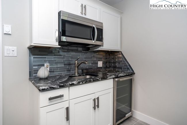 Wet bar with wine cooler and microwave. | Image 18