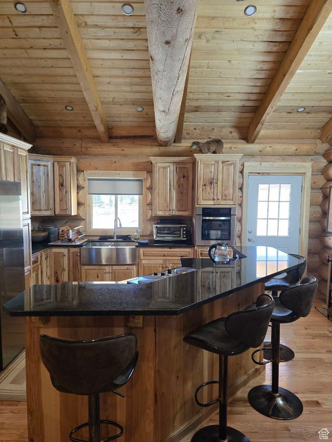 Kitchen with a sink, plenty of natural light, appliances with stainless steel finishes, and light wood-style flooring | Image 54
