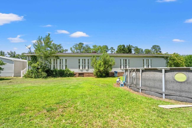 Rear view of property featuring a lawn and french doors | Image 29