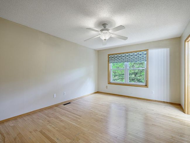 The main floor primary bedroom offers a sizeable space to make your own. | Image 11