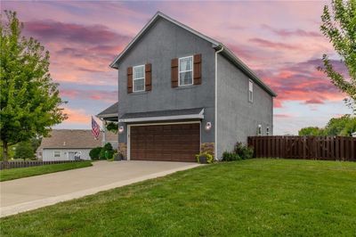 View of front of home featuring a yard and a garage | Image 2