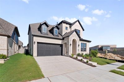 View of front of property with a garage, central AC, and a front lawn | Image 1