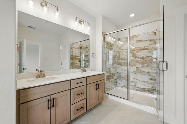 Vanity space for 2 and a spacious walk in shower are only a few of the thoughtful design elements you will find in our Camille I plan Owner's Suite. | Image 14