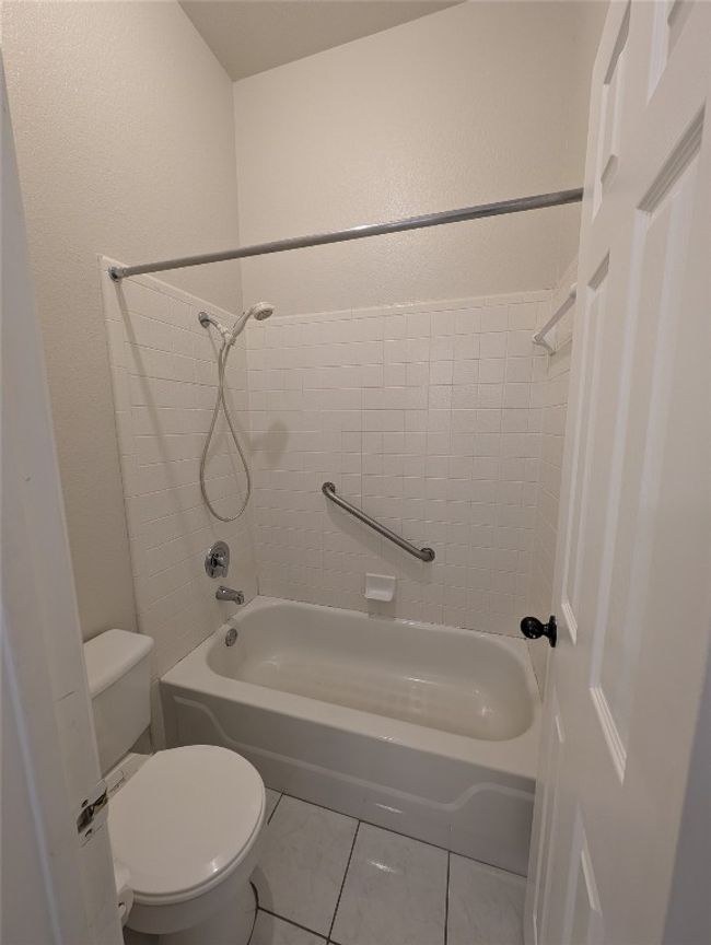 Bathroom featuring bathing tub / shower combination and tile patterned floors | Image 20