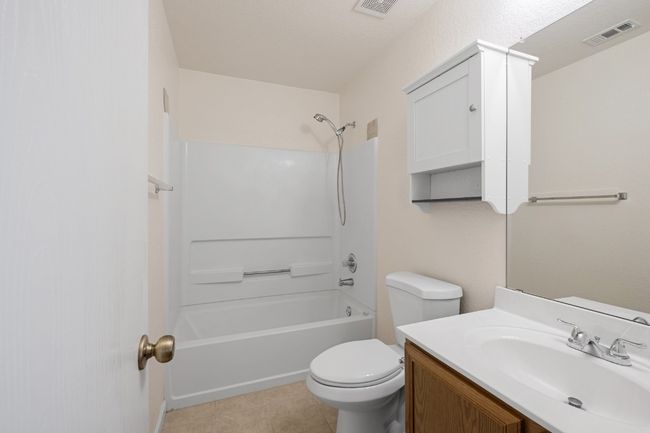 Full bath with vanity, shower / washtub combination, and tile patterned flooring | Image 25