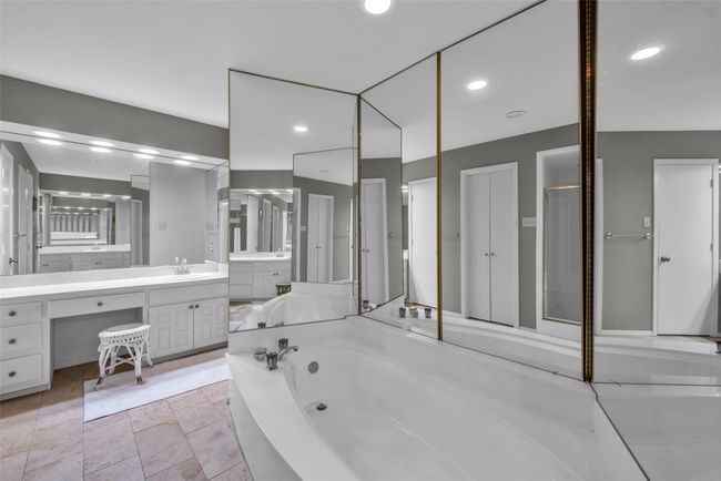 Primary bath has separate sinks and walk-in closets with incredible lighting from all the mirrors! | Image 22