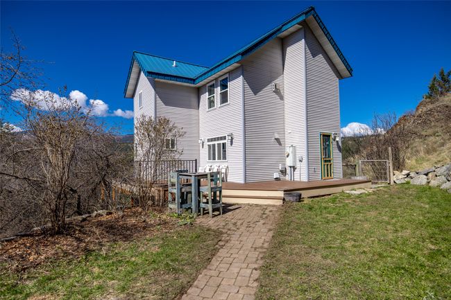 Back of property featuring a wooden deck, a yard, and metal roof | Image 81